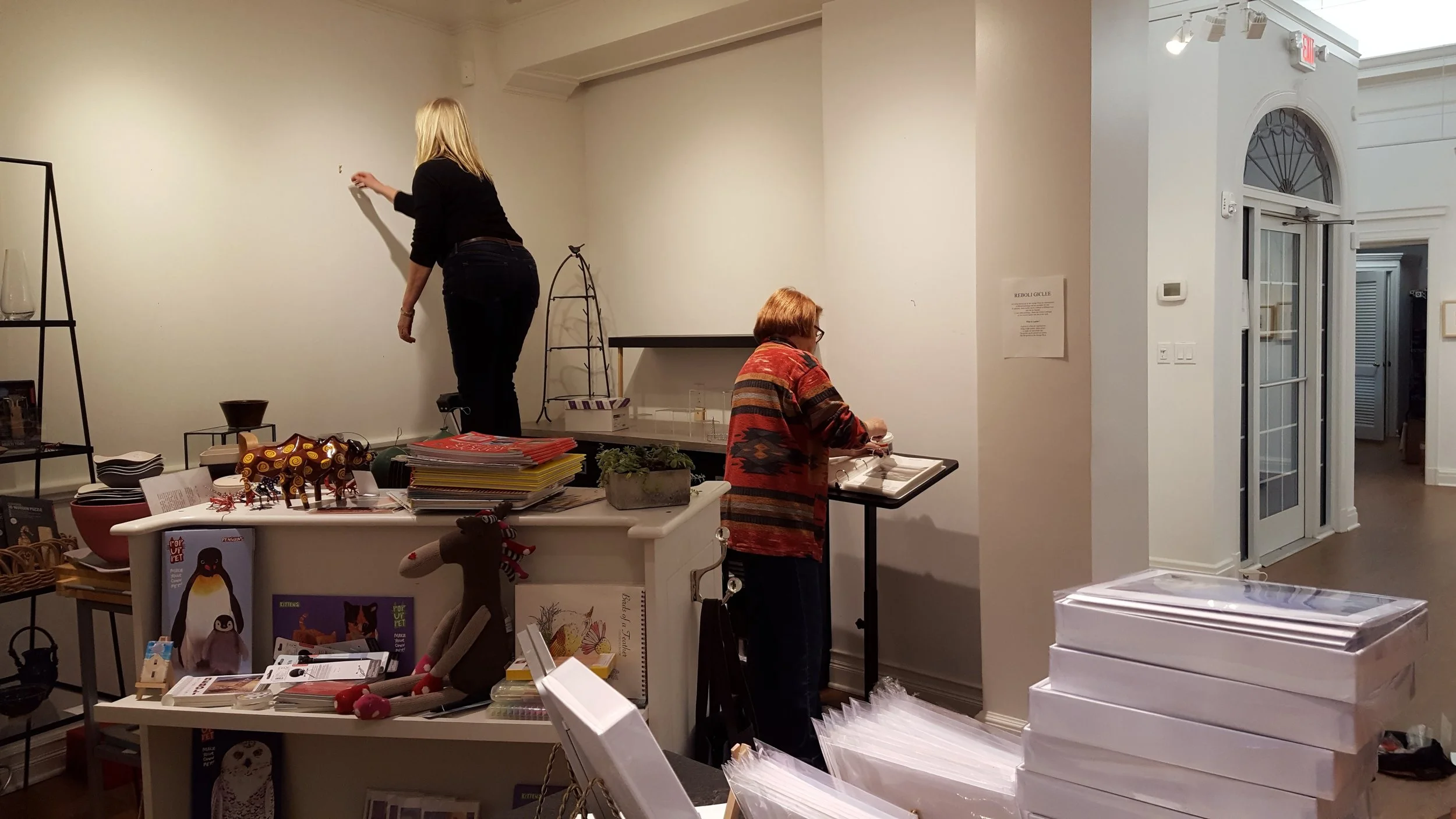Lois Reboli, Pam Brown, and Cathy Haenlein working on changing the exhibit.