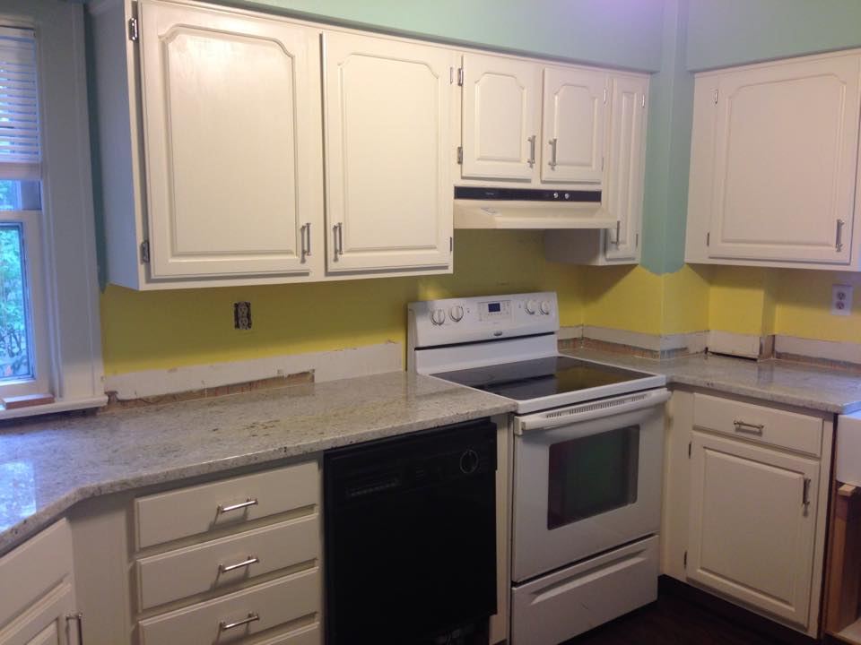 Change comes in shades of yellow! Finished paint and counters, but no back splash to cover the clashing wall strip!