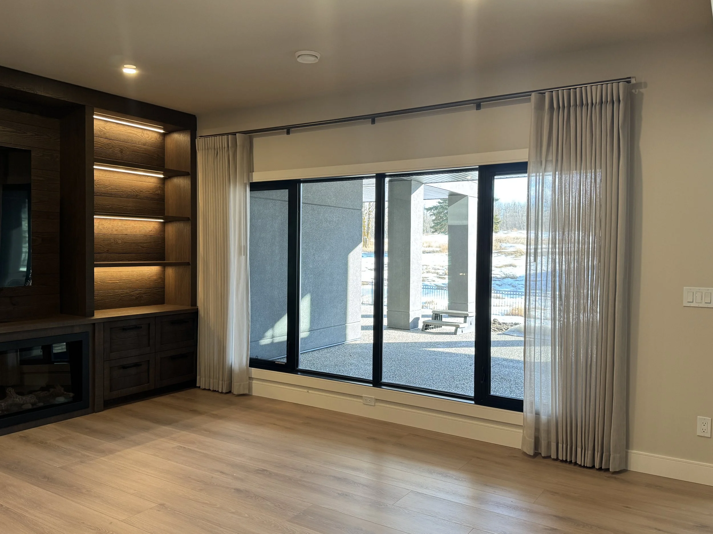 Drapes fitted over a large window with a black frame