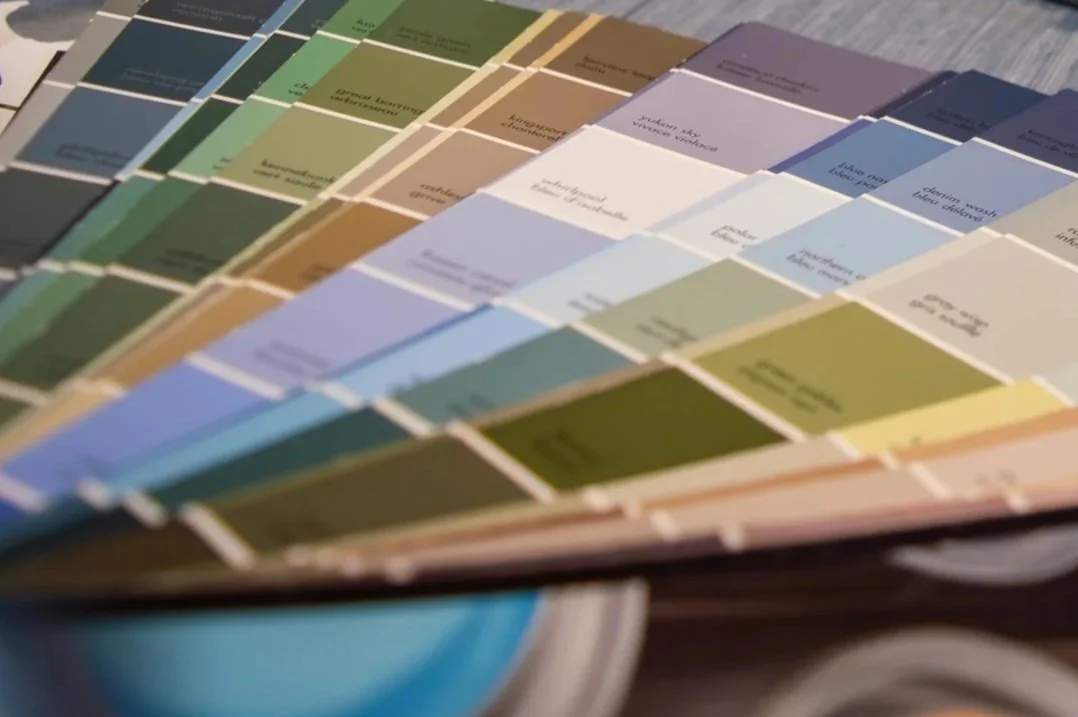 Photo of paint chips fanned out on a table.