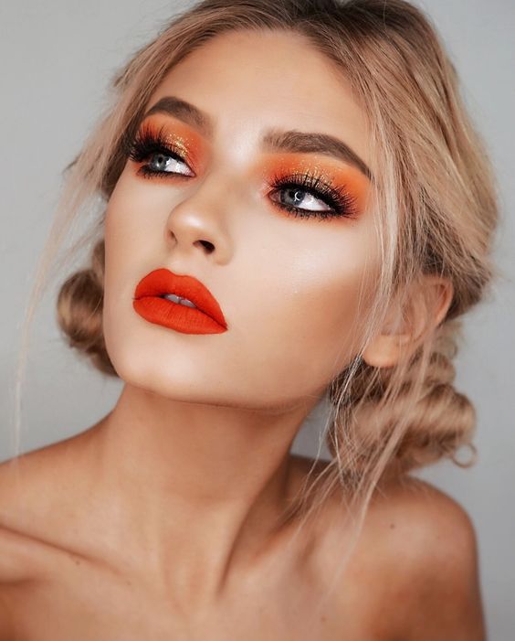 Wanting to go bold this Spring? Neons are your gateway to being on trend this season. Bright and flashy is the new hot look, and we love the use of neon orange in this look, along with the paired warm red shade of lipstick! (Source)