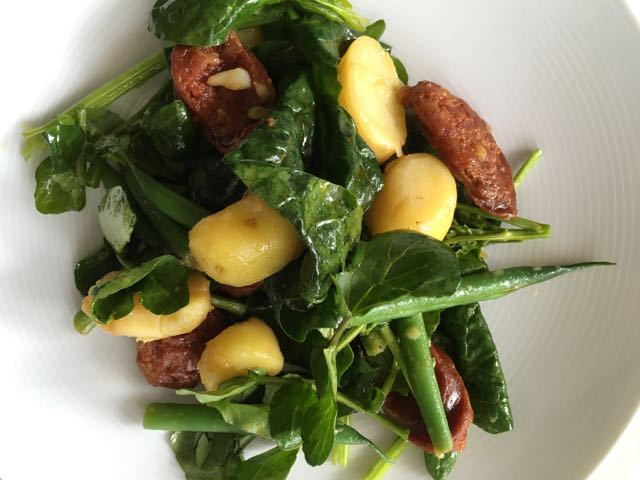 A Late Spring Salad Photo ©Evie Saffron Strands A Late Spring Salad (Serves 4) 300g Fine Green Beans 800g waxy potatoes (e.g. Jersey Royals, La Ratte) 250g cooking chorizo 2 good handfuls of young spinach leaves or watercress (or a mixture), washed and dried. Dressing: 2 tablespoons of Sherry Vinegar Salt and pepper to taste 6-7 tablespoons Olive Oil Wash the potatoes (skin on or off, as you prefer) and boil for 15-20 minutes until cooked. Cut off the top of beans, wash and boil in salted water until just cooked(2-3 minutes). Drain the beans and plunge them into cold water to retain the colour before cutting them in half and drying them. Thickly slice the chorizo and fry in a hot pan until softened and slightly coloured. Mix your Dressing in a large serving bowl. Drain and slice the potatoes thickly before adding them to the dressing while still warm. Add the cooked beans and the chorizo and stir. Add the spinach (or other) leaves. Mix gently and serve.