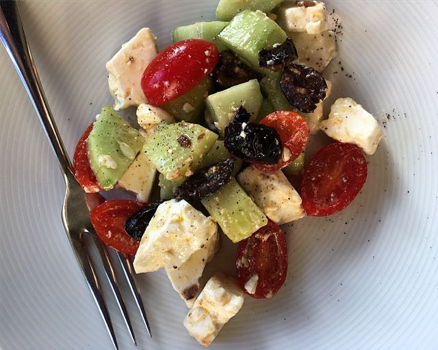 Feta Salad Photo ©Evie Saffron Strands The heat of July brings with it a longing for cooling salads – the last thing we want to do at this time is stand at a hot stove. This ‘recipe’ fits the bill. I’ve deliberately called it Feta Salad, rather than Greek Salad, as this assemblage is the way we make it and may not bear scrutiny as truly authentic. You could add thinly sliced red onion, which our Greek customers would approve of, I think, and some add sliced green pepper too. Whether you peel your cucumber or not is a matter of preference and, maybe, the variety of cucumber. Feta Salad (Serves 4) 300-400g Feta Cheese, roughly crumbled 2-3 small Cucumbers (or 1 large), cut into chunks 2 vines of Tomatoes, halved 150g Black Olives (preferably Kalamata) 1 smalll Red Onion, thinly sliced (if liked) 1 green pepper (if liked) 1 tablespoon Red wine vinegar or Lemon juice 4 tablespoons Extra Virgin Olive Oil A little Fresh or dried Oregano (unless using herbed olives) Mix together the wine vinegar/lemon juice and olive oil and add the oregano. Add the rest of the ingredients and mix carefully but thoroughly. Particularly good served with Pita Bread to mop up the juices.