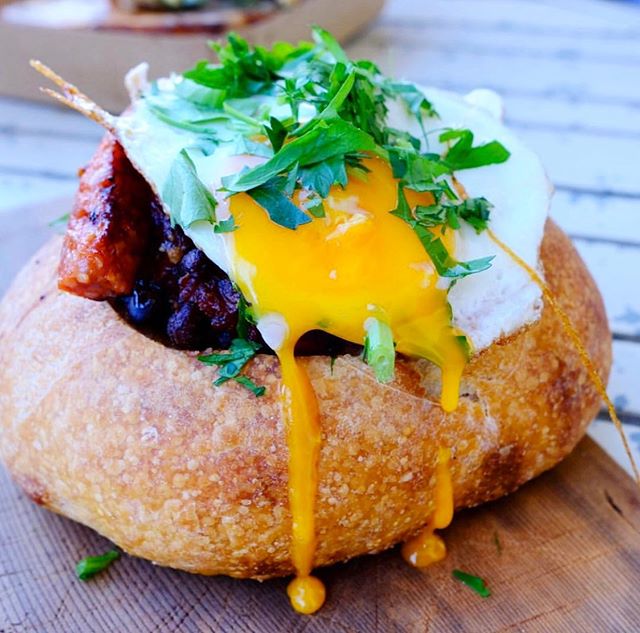 BREAKFAST IN BREAD || Chorizo Sausage, black beans, queso fresco, red capsicum, onion, mushroom, spinach, chipotle ranchero sauce, served in a Paddock wood-fired sourdough bread bowl, then topped with Mozzarella &amp; a fried egg 🍳.
It&rsquo;s so ex