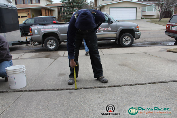 Measure gaps, ridges and joints in the concrete driveway.