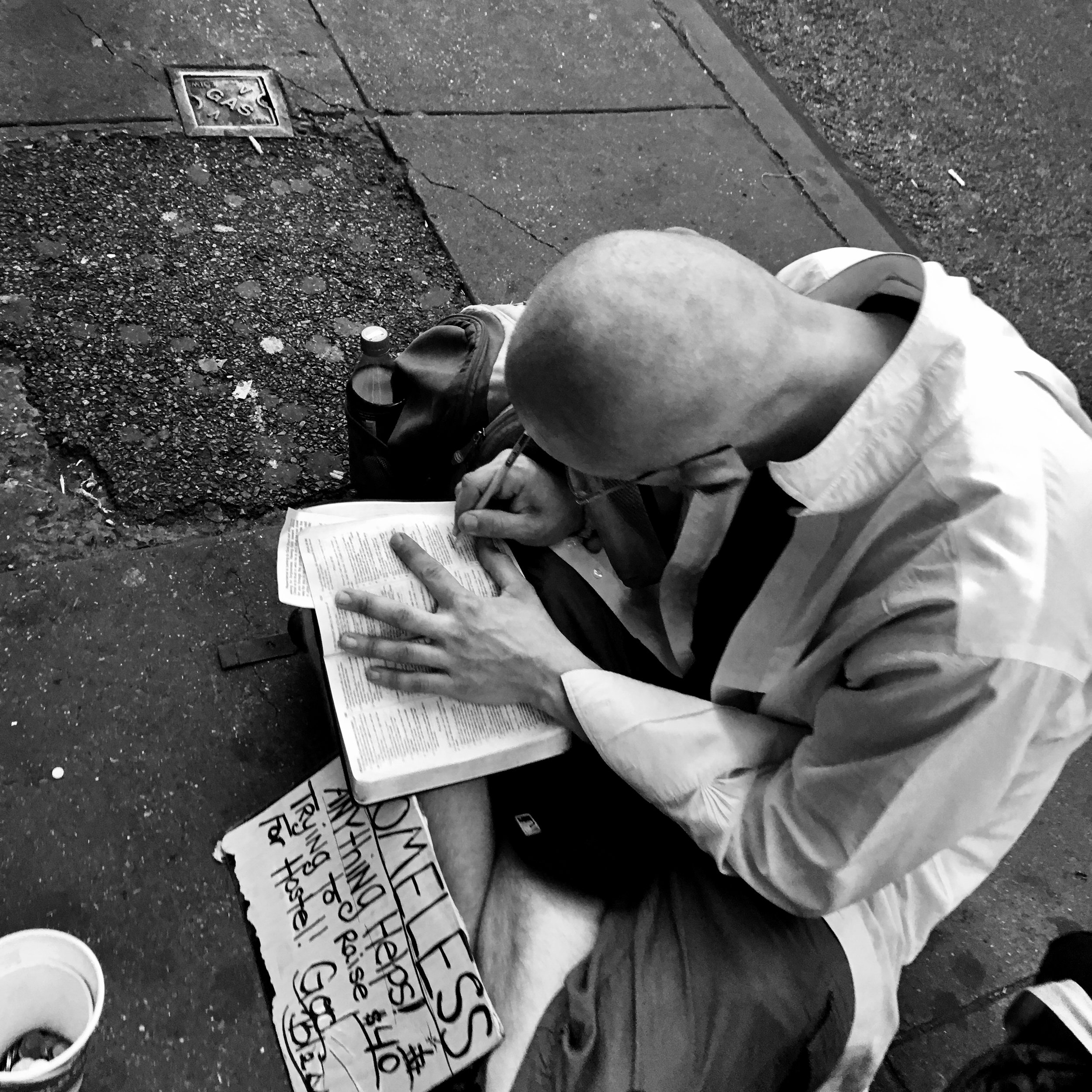 homeless man writing.jpg