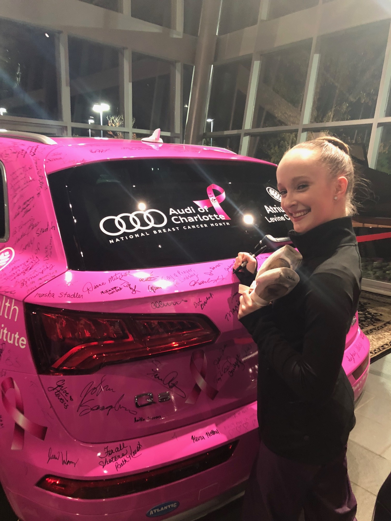 Signing to up Audi Charlotte's donation to GoJenGo, fighting breast cancer