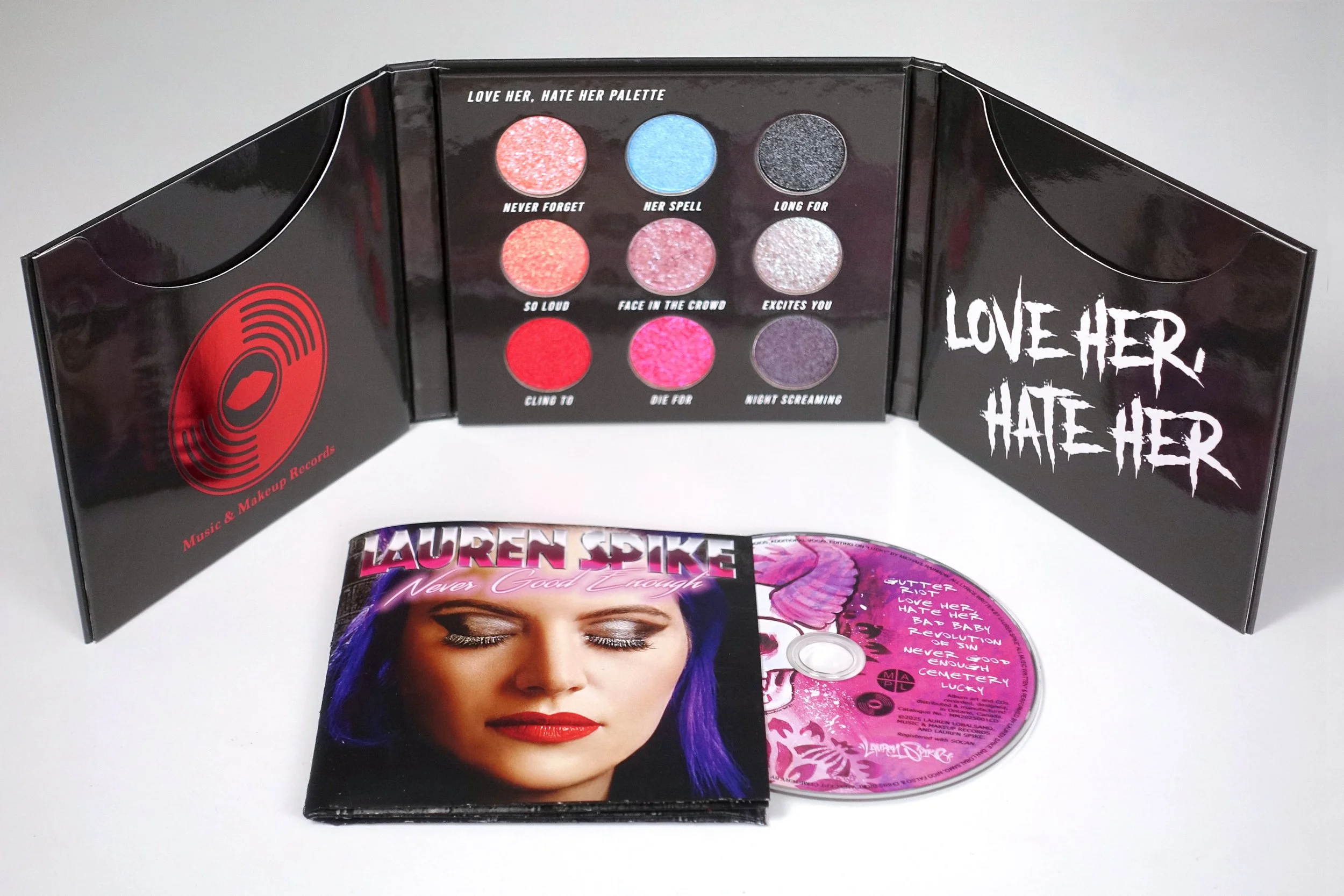 Love, Her Hate, Her Eyeshadow Palette. Eyeshadow colours  Shimmer Blush/ Peach/Mauve, Baby Blue, Glitter Black,  Gun Metal, Metallic Red/Magenta/Dark Purple. With CD album cover of Red Devil Girl Logo