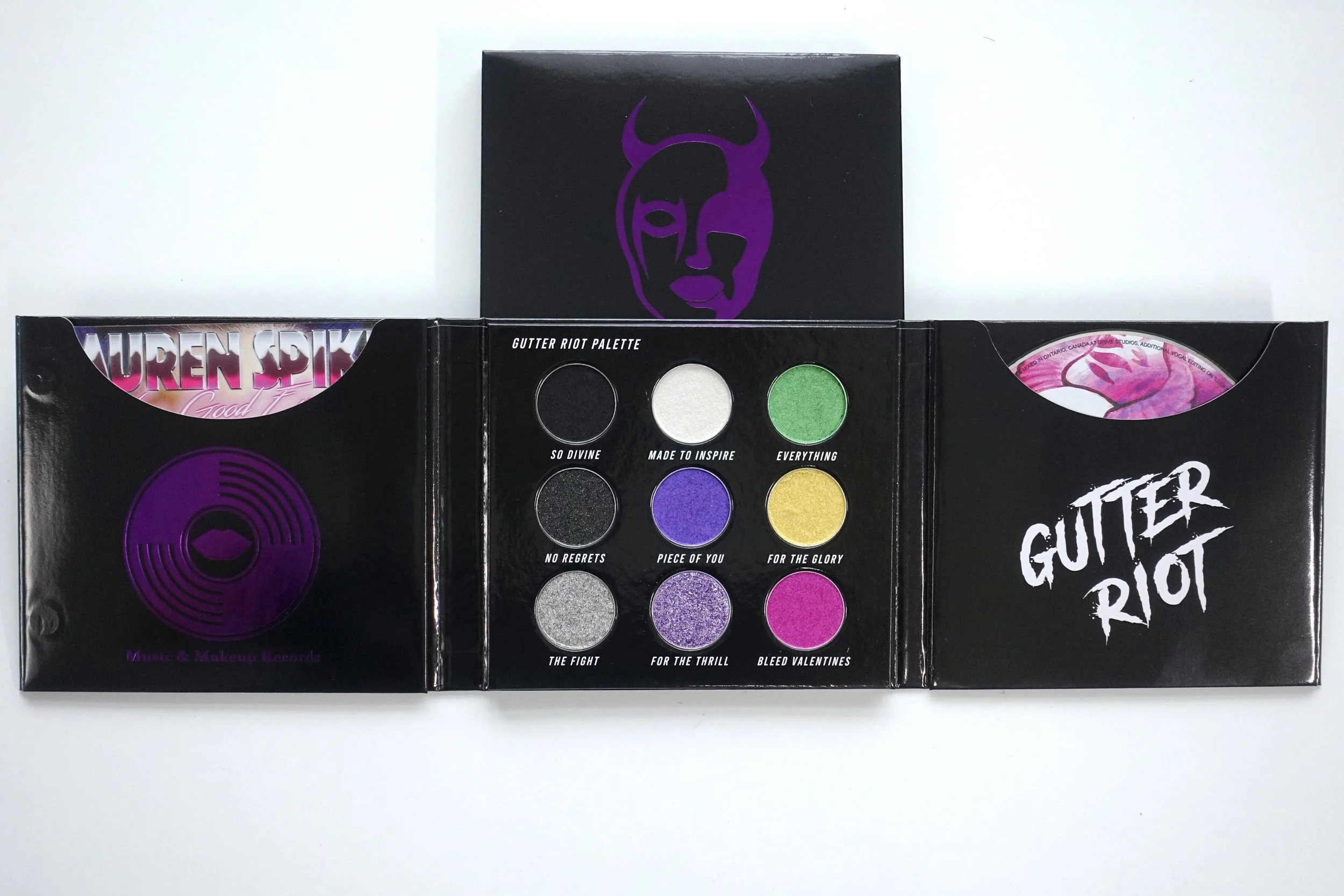 Gutter Riot Eyeshadow Palette with colours Black, Green, White, Sparkle Black, Purple, Yellow, Silver, Glitter Purple, Magenta. CD album cover Purple Devil Girl Logo