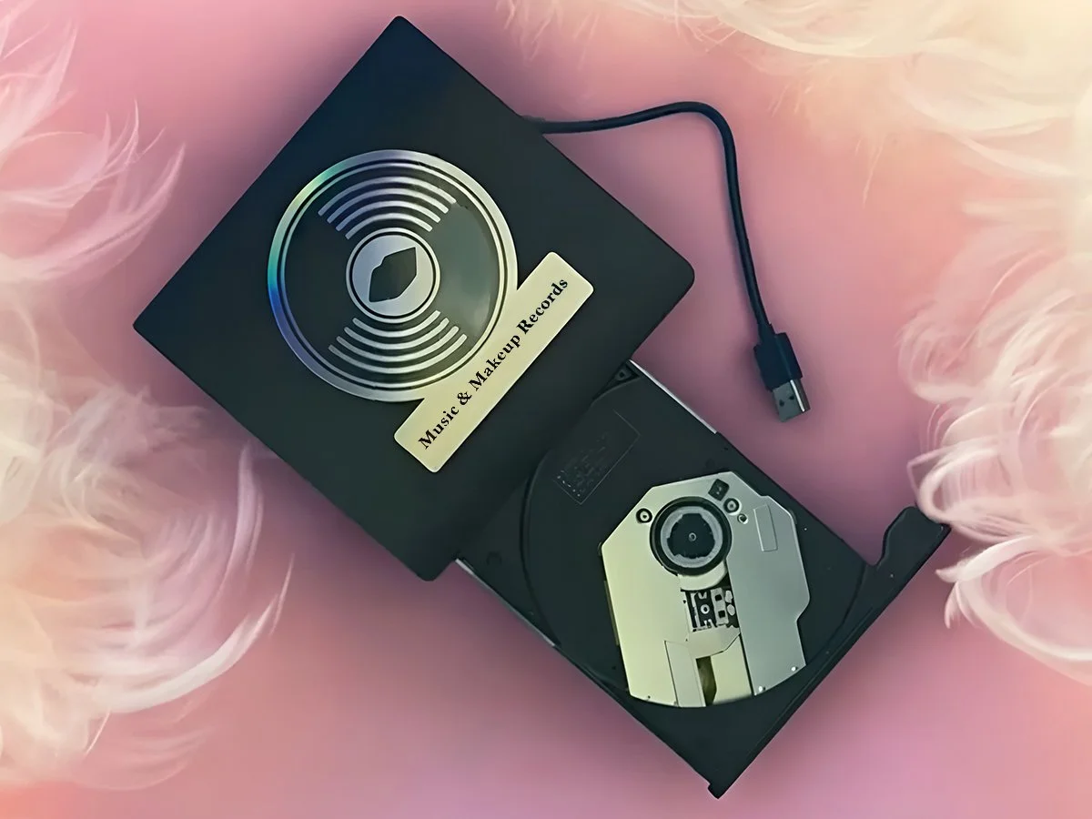 External CD/DVD-RW player. Plug and play USB plug in with a Type C adapter. Colour: black. Music & Makeup Records logo on top.