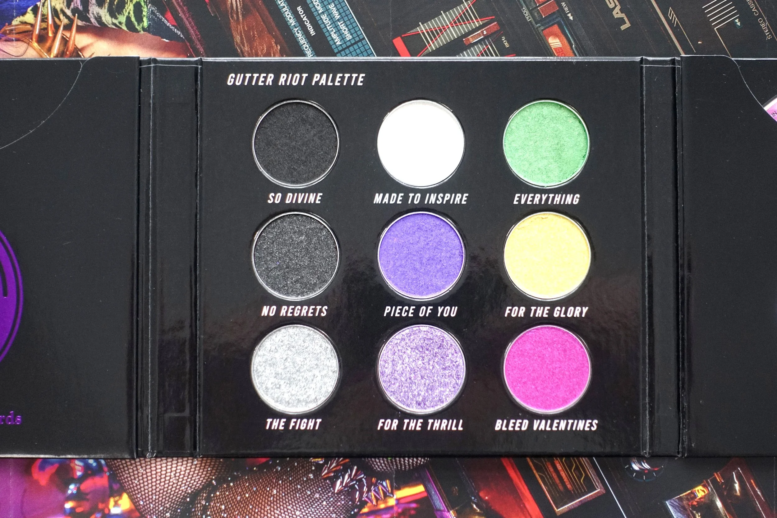 Gutter Riot Eyeshadow Palette. Eyeshadow colours Black, Green, White, Sparkle Black, Purple, Yellow, Silver, Glitter Purple, Magenta