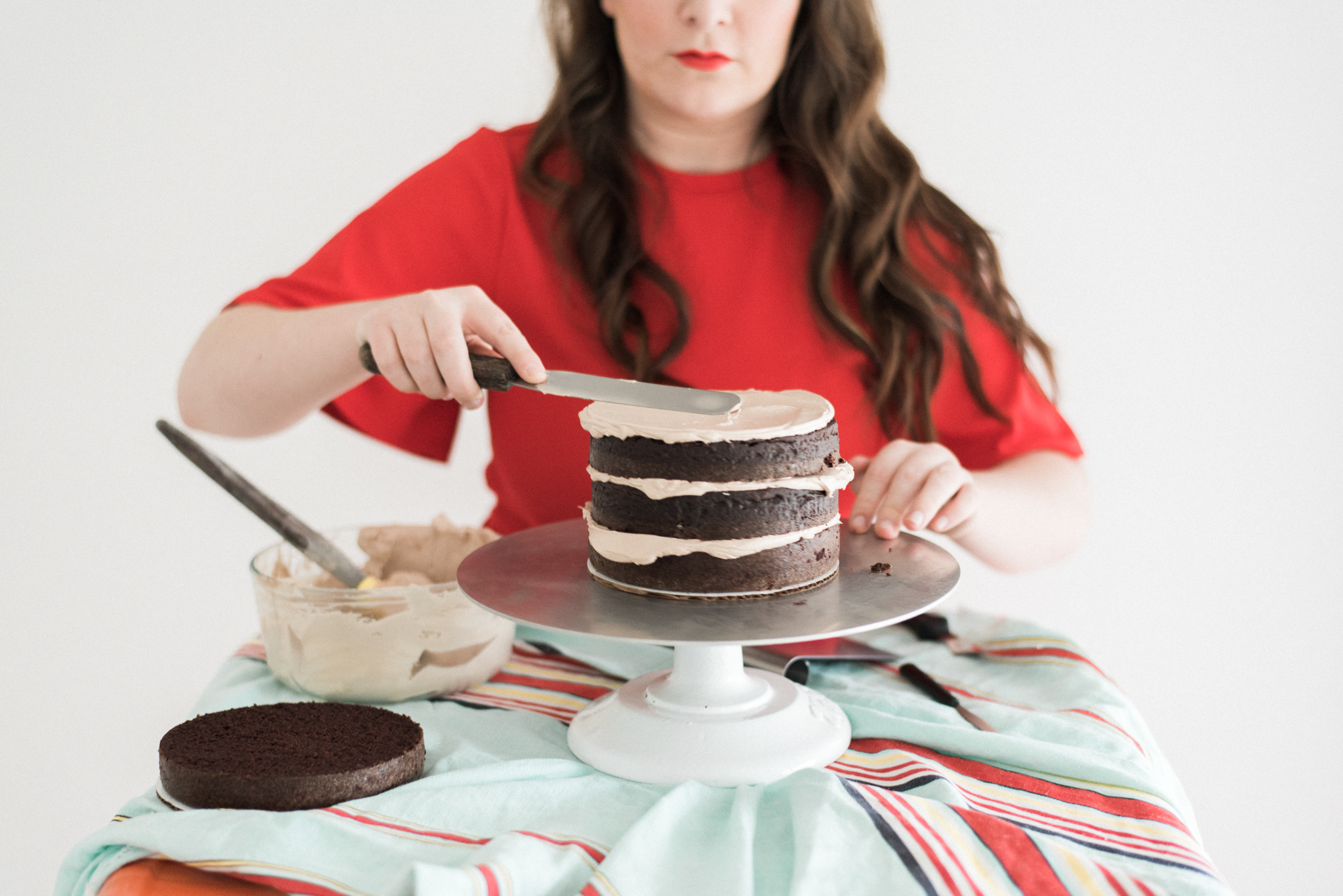 Bellingham cake maker, Saltadena, carefully stacks her cake layers. 