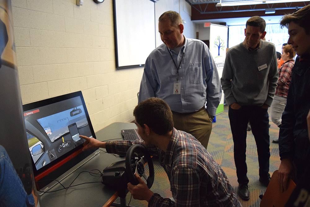 Farwell Junior Adam VanBuskirk attempts to text while driving on the simulator at the #DriveSafeCTE launch assembly in January.