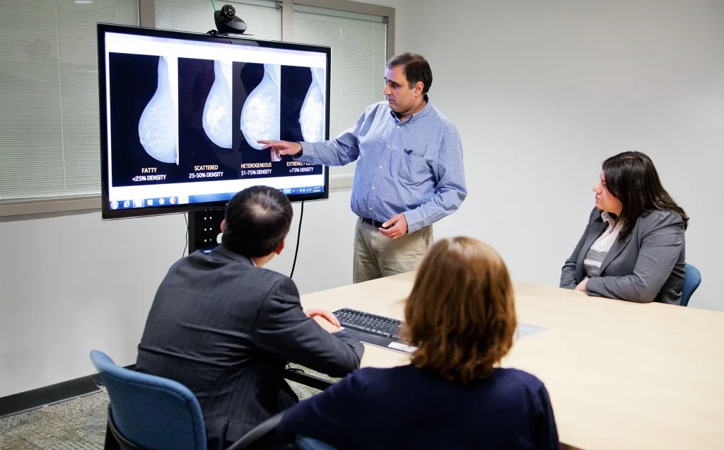 Densitas Inc.'s founder, Mo Abdolell, explains breast density measurements to staff