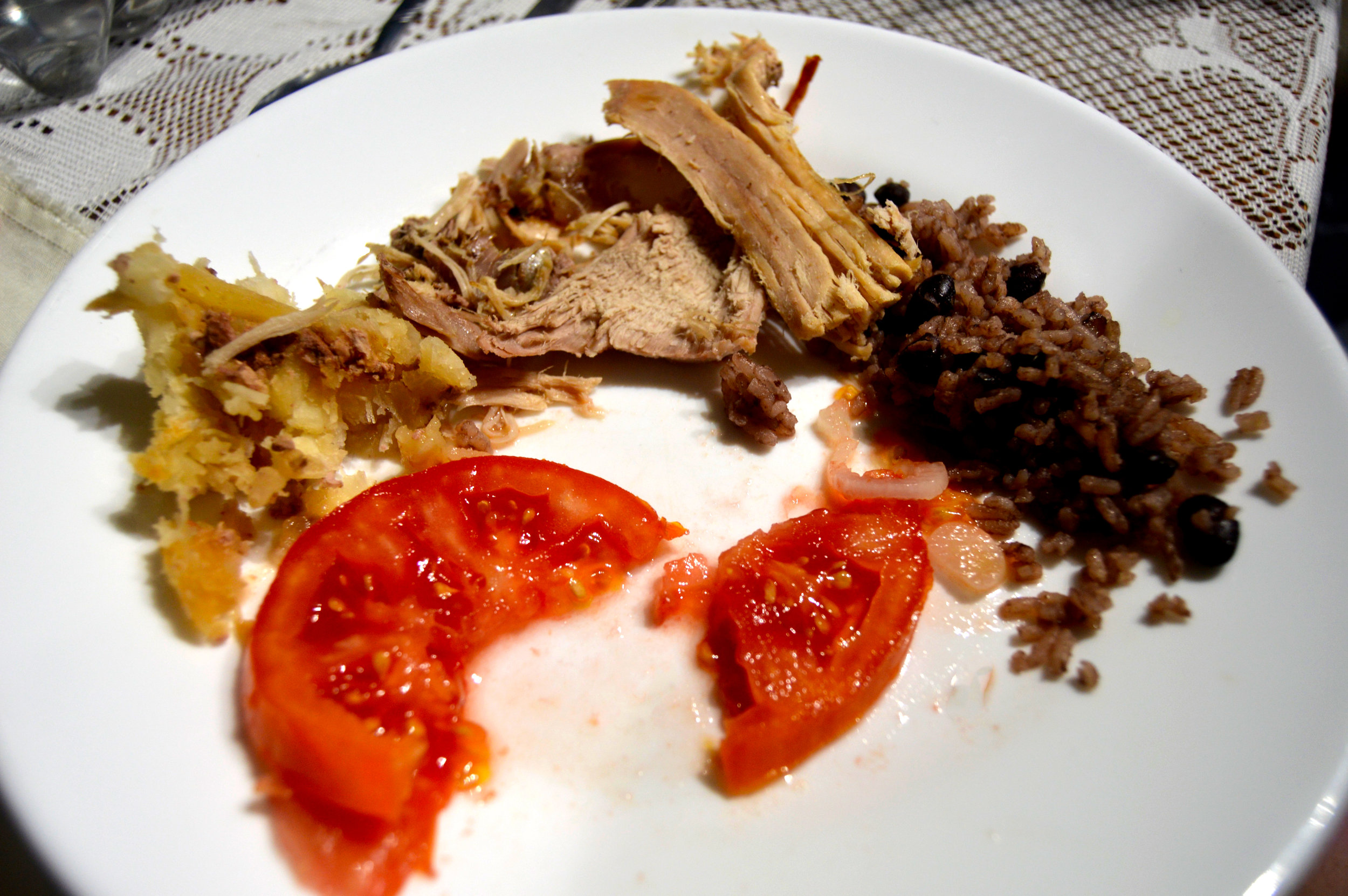 Writer Caroline Leland enjoyed a Cuban New Year's dinner of roasted pork, baked yucca, fresh sliced tomatoes, and congris (white rice mixed with black beans). Photo by Caroline Leland