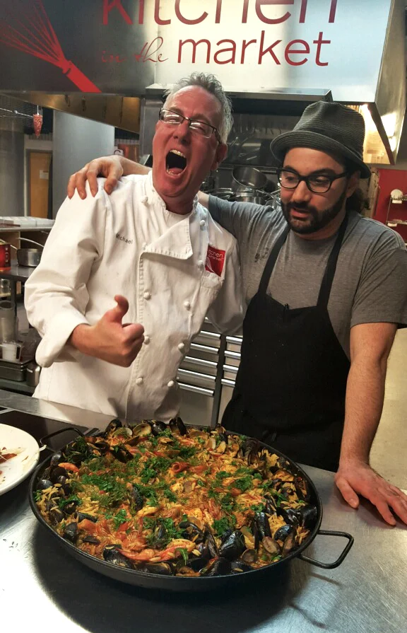 Kitchen in the Market 's Head Chef Michael Lamon (left) with World Street Kitchen and Milkjam Creamery owner Sameh Wadi are excited to eat some paella. Photo by Urmila Ramakrishnan