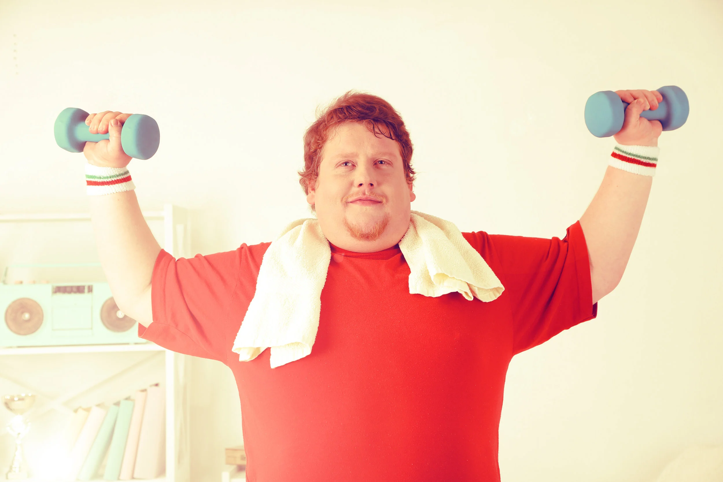 Large fitness man working out at home