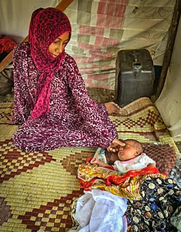 Syrian refugee woman and child from Aleppo, Syria at a makeshift tent camp in Turkey ( Christian Aid Mission )