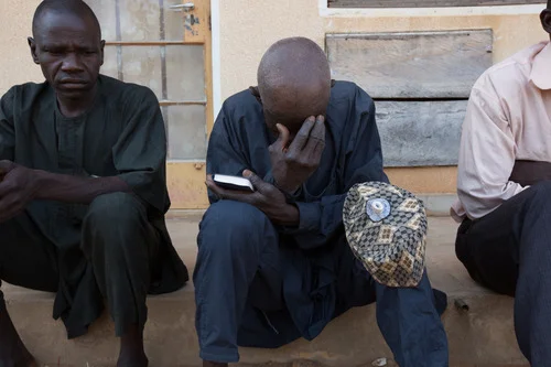 A man prays during Sunday service at the Damare IDP camp. The service provides a space for traumatised IDPs to begin the healing process by giving them strength through sermons and testimonies of survival, says John Nihanpa the camps pastor. 2014, © Rahima Gambo