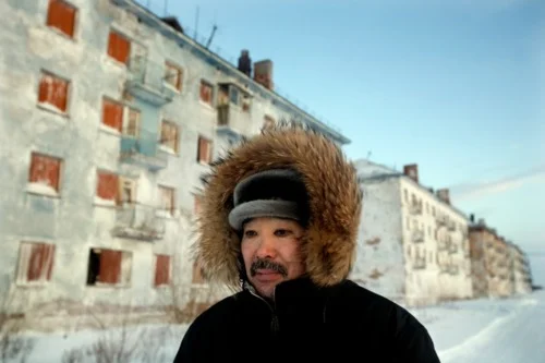 Karp Belgayev, a coal miner, walks through Yor Shor, an abandoned village near Vorkuta where he is among the last ten inhabitants. Miners say that after ten years working underground it is impossible to remove black rings from around the eyes.