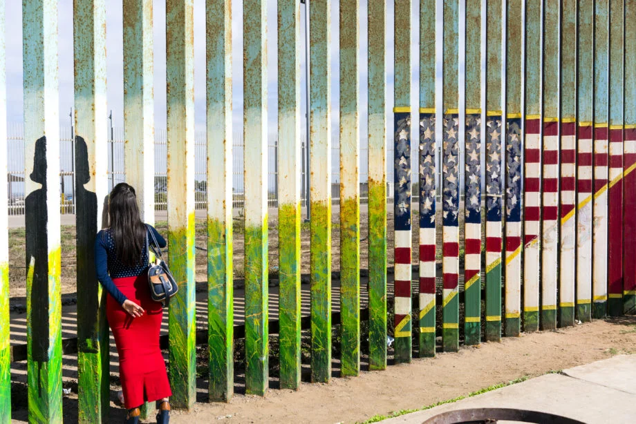 Nick Oza. Women looking through the fence in Tijuana, Mexico, talking to a family member on the U.S. side, September 22, 2017.