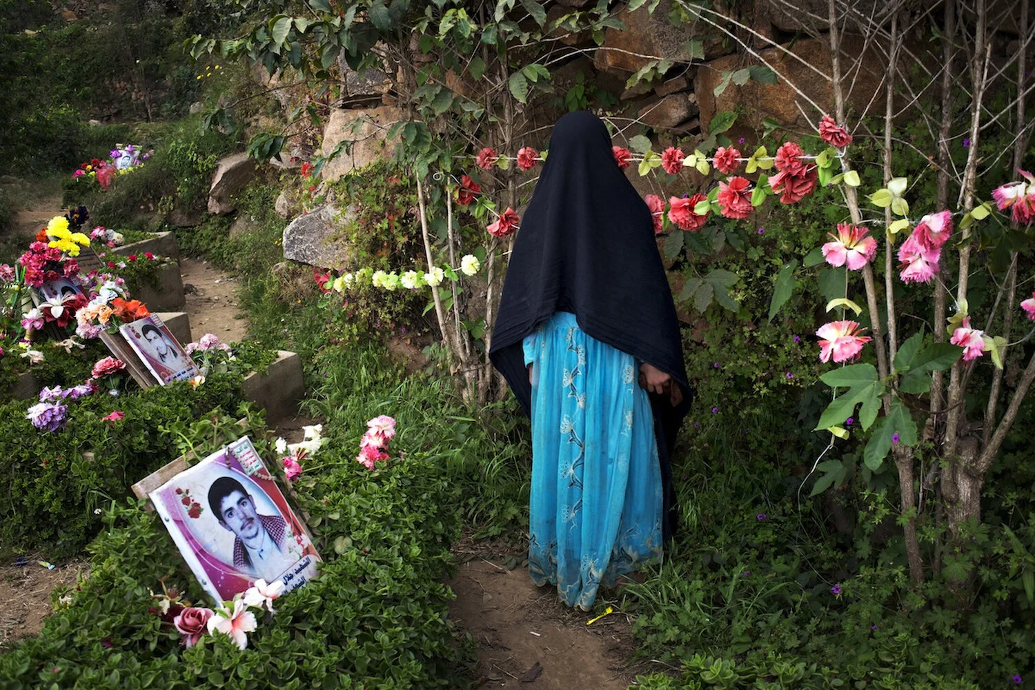  A Yemeni girl visits the graves of martyrs of the previous wars in Marran, Saada, the village where the Houthi movement started. 