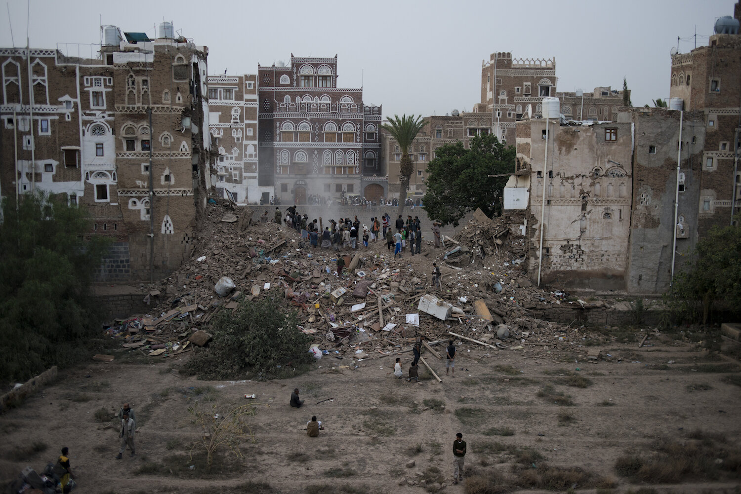  Rescuers, mostly neighbors and local men, attempt to dig a family out of a collapsed home in the Old City on Friday, June 12, 2015 in Sana'a, Yemen. Four houses collapsed after a Saudi airstrike in the city. It is unclear if an unexploded rocked lan