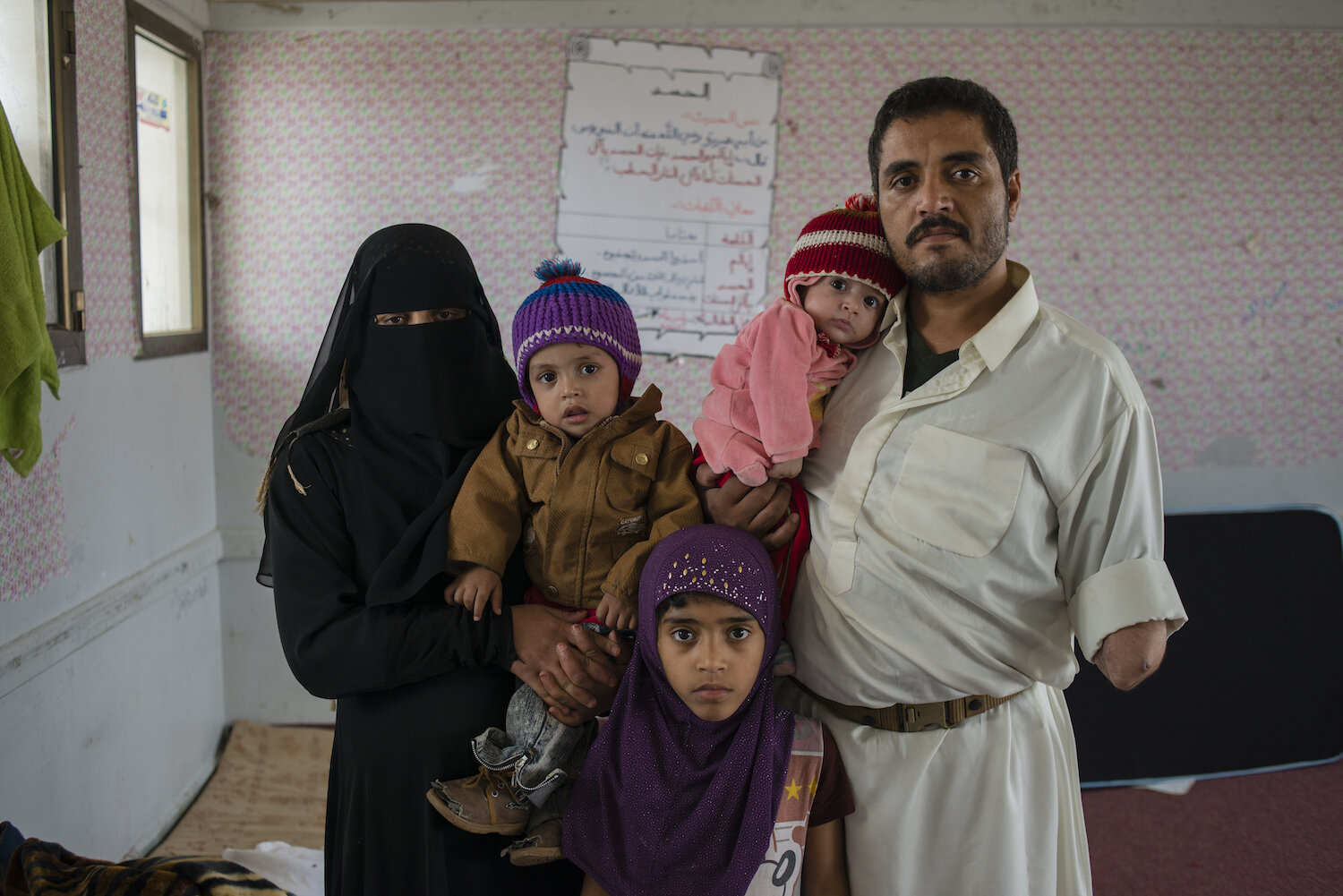  Mohammad Abdulrab Qahed stands for a portrait with his wife, Um Saad , and children Imad, Wiam, and Dua'a, at a school where they now live in Sana'a, Yemen on June 10, 2015. They are just one family out of the nearly 1.3 million Yemenis forced to le