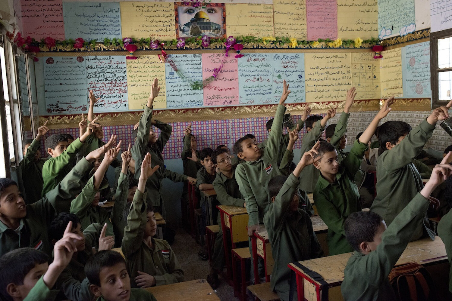  Yemeni boys in the Houthi stronghold of Sa'ada raise their hands at school. The government was rebuilt between the previous wars and the revolution. 