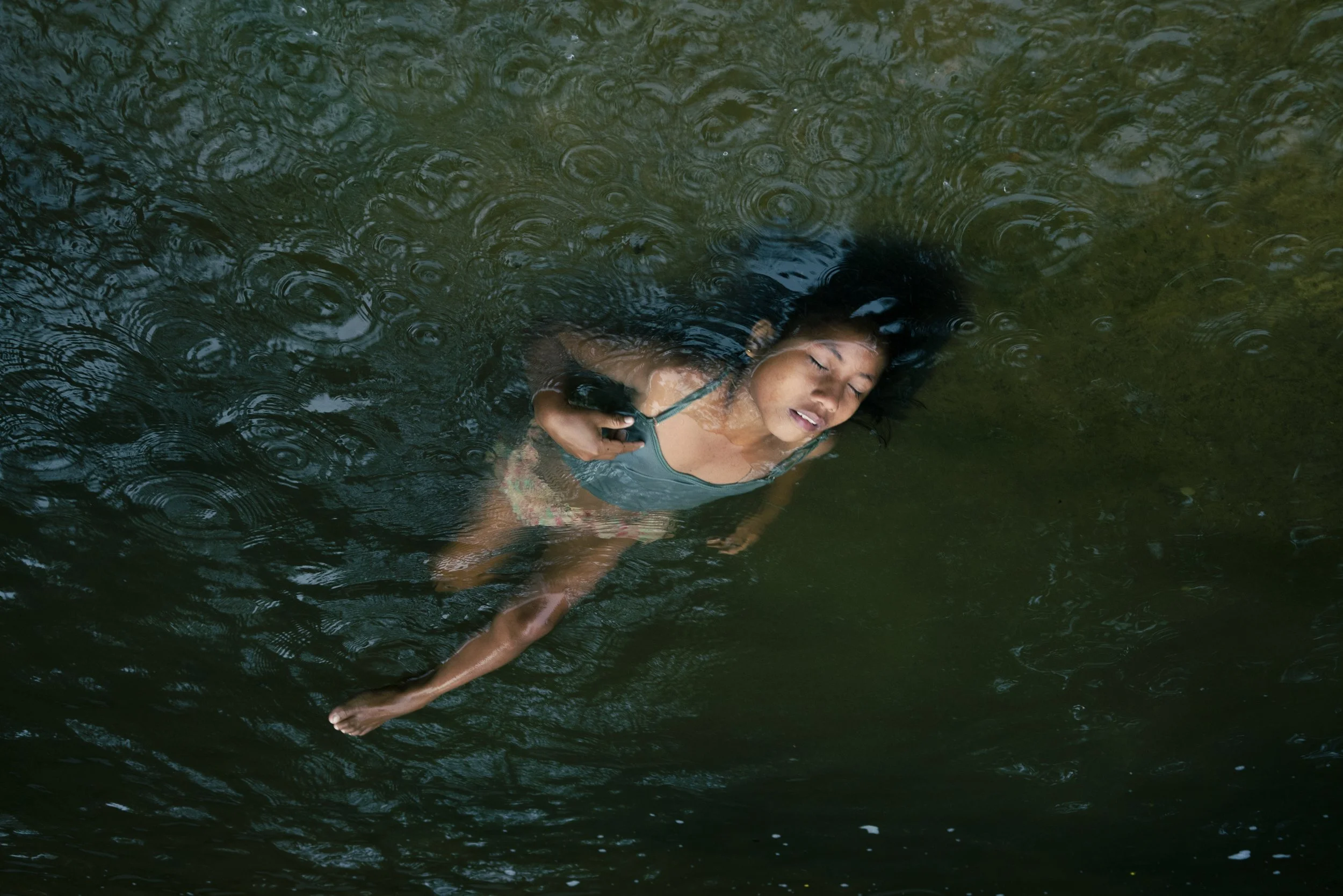  Shaman Jattupa’s granddaughter Diana, 11, floats in the river near the Huöttöja community in the Amazonas state, Venezuela. 