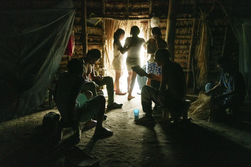  Children exit the Huöttöja people’s communal hut to go bathe in the river in the Amazonas state, Venezuela. This construction typically lasts eight years. This one is two years old. 