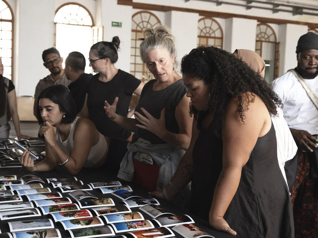  Fellows and MF team members look at work by Giya Makondo-Wills. Photo by Isadora Romero.  