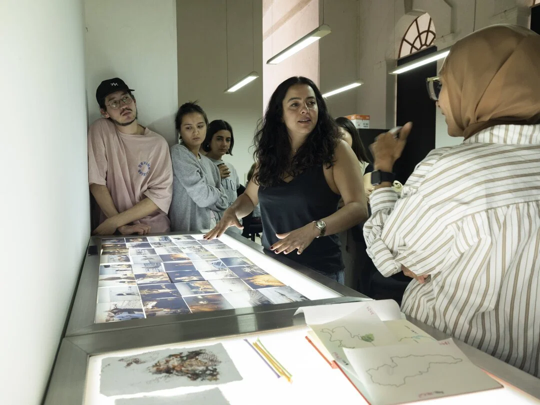  Mentor Newsha Tavakolian leads a discussion that includes topics such as generating authentic aesthetic strategy, creating context for photography installed within communities, and harnessing emotion as motivation for producing work. Photo by Isador