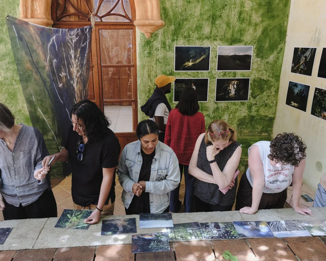  Heat Fellowship workshop participants look at work by Andrea Hernández Briceño. 