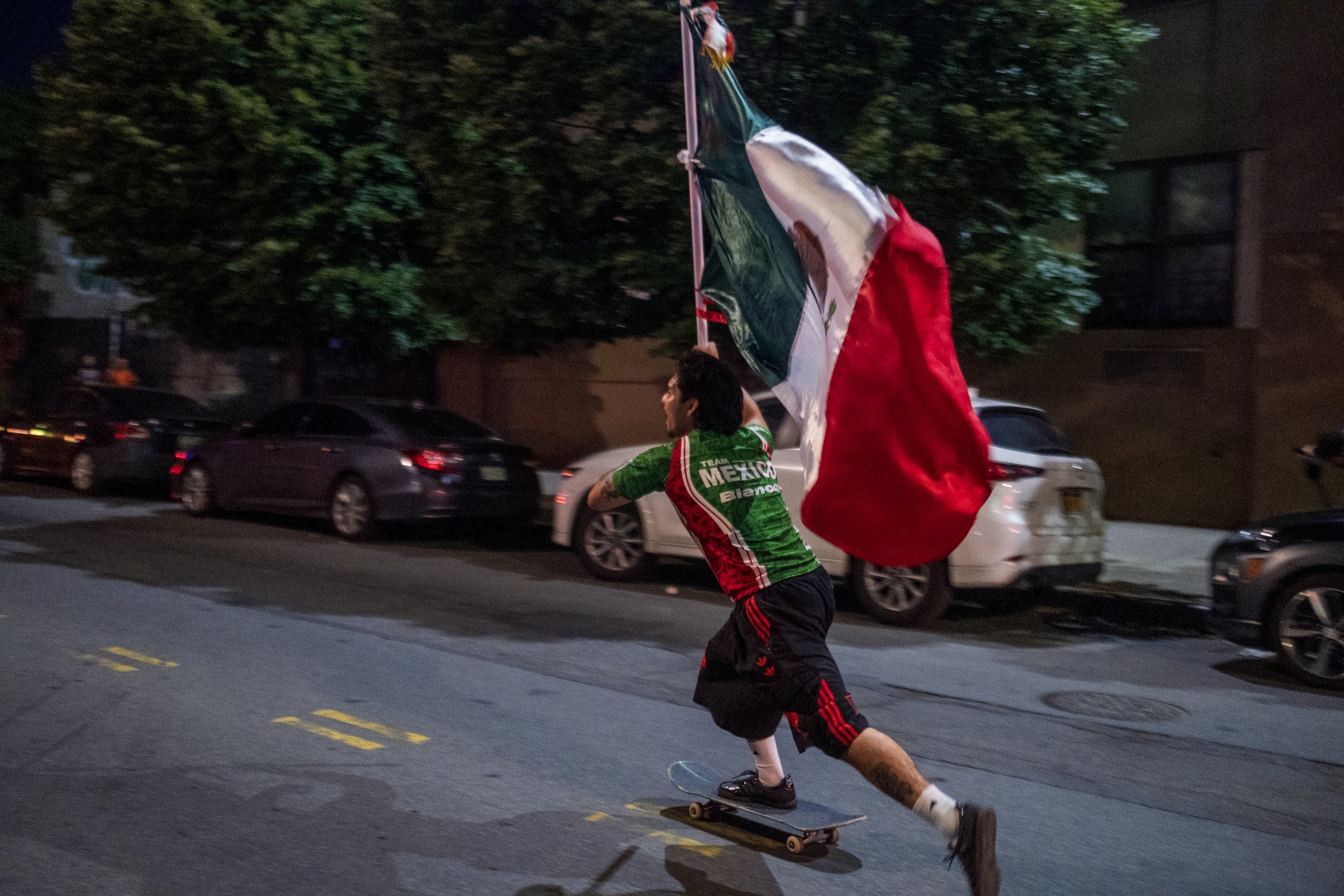  A skateboarder cruises through the streets of Bushwick, Brooklyn, proudly waving a Mexican flag after Mexico’s victory over Czechia during the 2026 FIFA World Cup outside Football Café on June 24, 2026. 