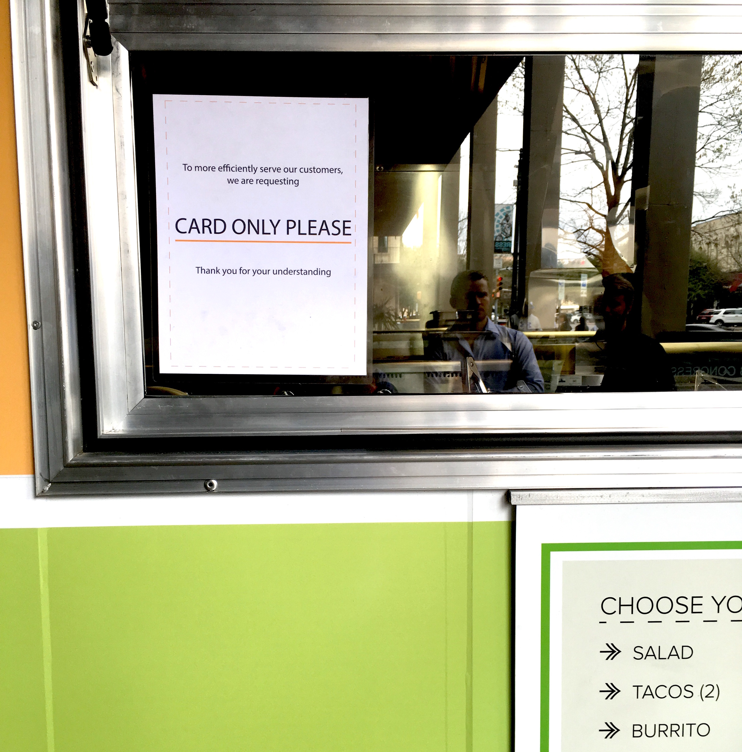 Sign in the window of Chi'lantro in Austin, TX informing customers that they are only taking cards.