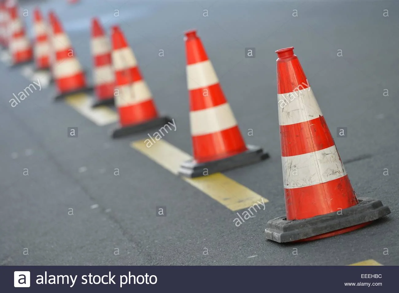 orange-traffic-cone-row-on-a-street-germany-city-of-hannover-14-january-EEEHBC.jpg