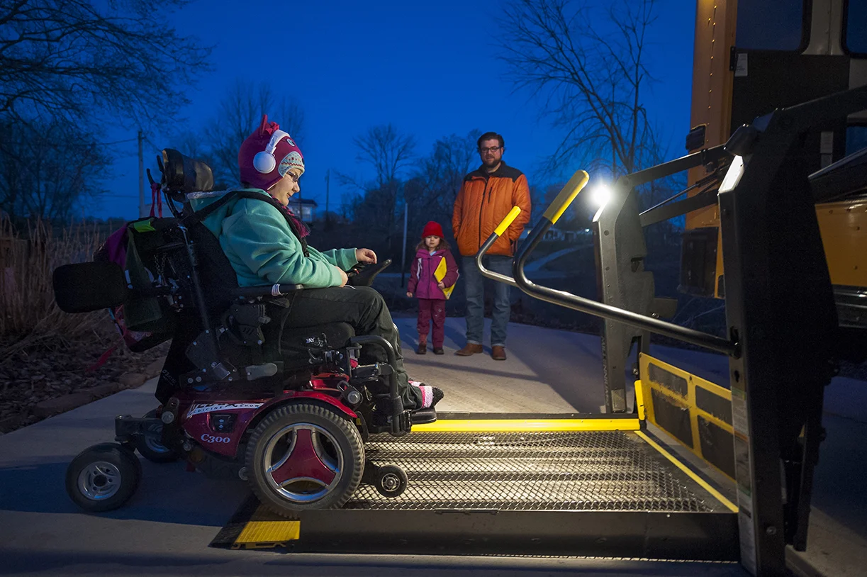  Adyn proceeds to get on the 7:15 a.m. bus to go to school while her dad Brian and younger sister Seneca watch on. According to Brian Bucher, Adyn’s father, there are only two busses that are handicap accessible in Athens County. “It makes my morning