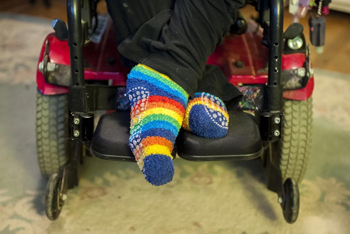  Adyn sits in her living room while she watches television. 