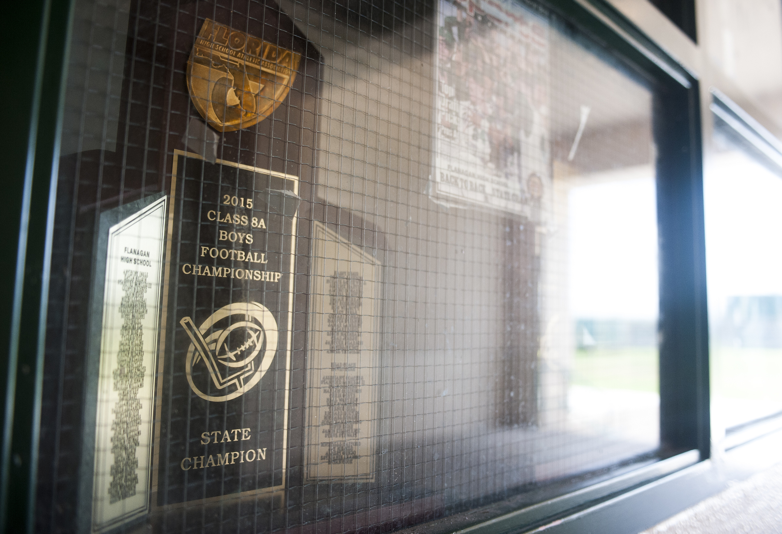 The 2015 state championship trophy sits in the tunnel next to the locker room during the first practice of the high school football season at Flanagan High School on Monday, Aug. 1, 2016. The reigning state champions look to repeat again despite the loss of key players from last year.