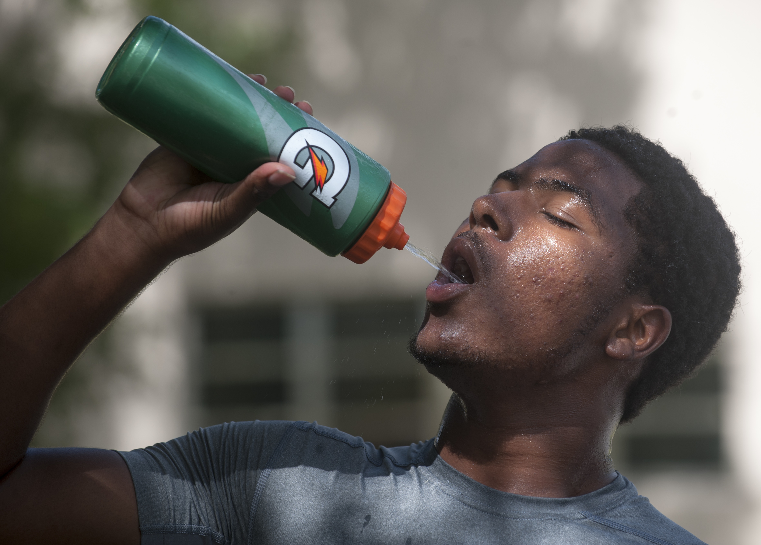  Flanagan high school junior wide receiver Shamar Nelson drinks water to cool off during the first practice of the high school football season at Flanagan High School on Monday, Aug. 1, 2016. The reigning state champions look to repeat again despite 