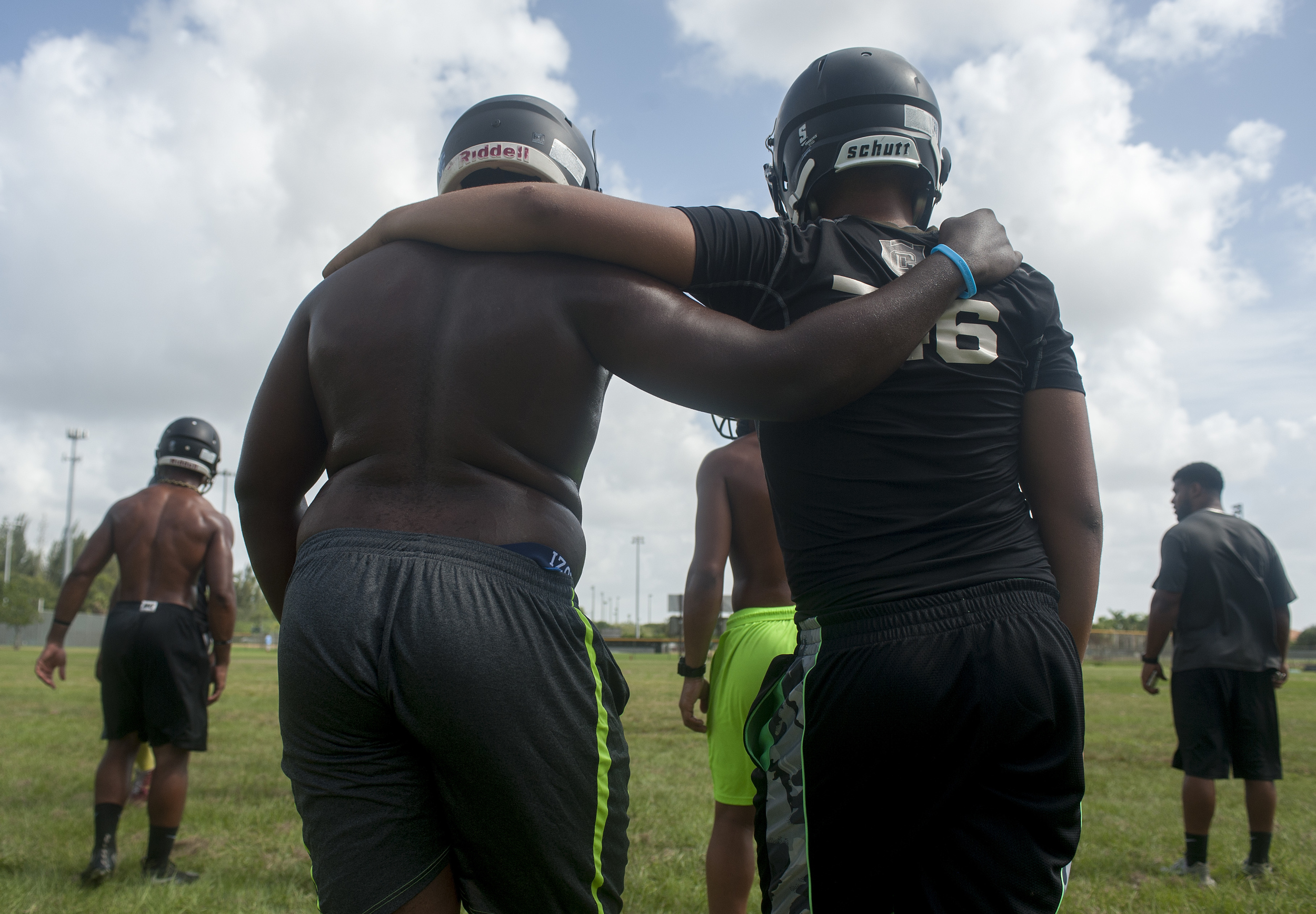  Flanagan high school football teammates help each other get through condition drills during the first practice of the high school football season at Flanagan High School on Monday, Aug. 1, 2016. The reigning state champions look to repeat again desp