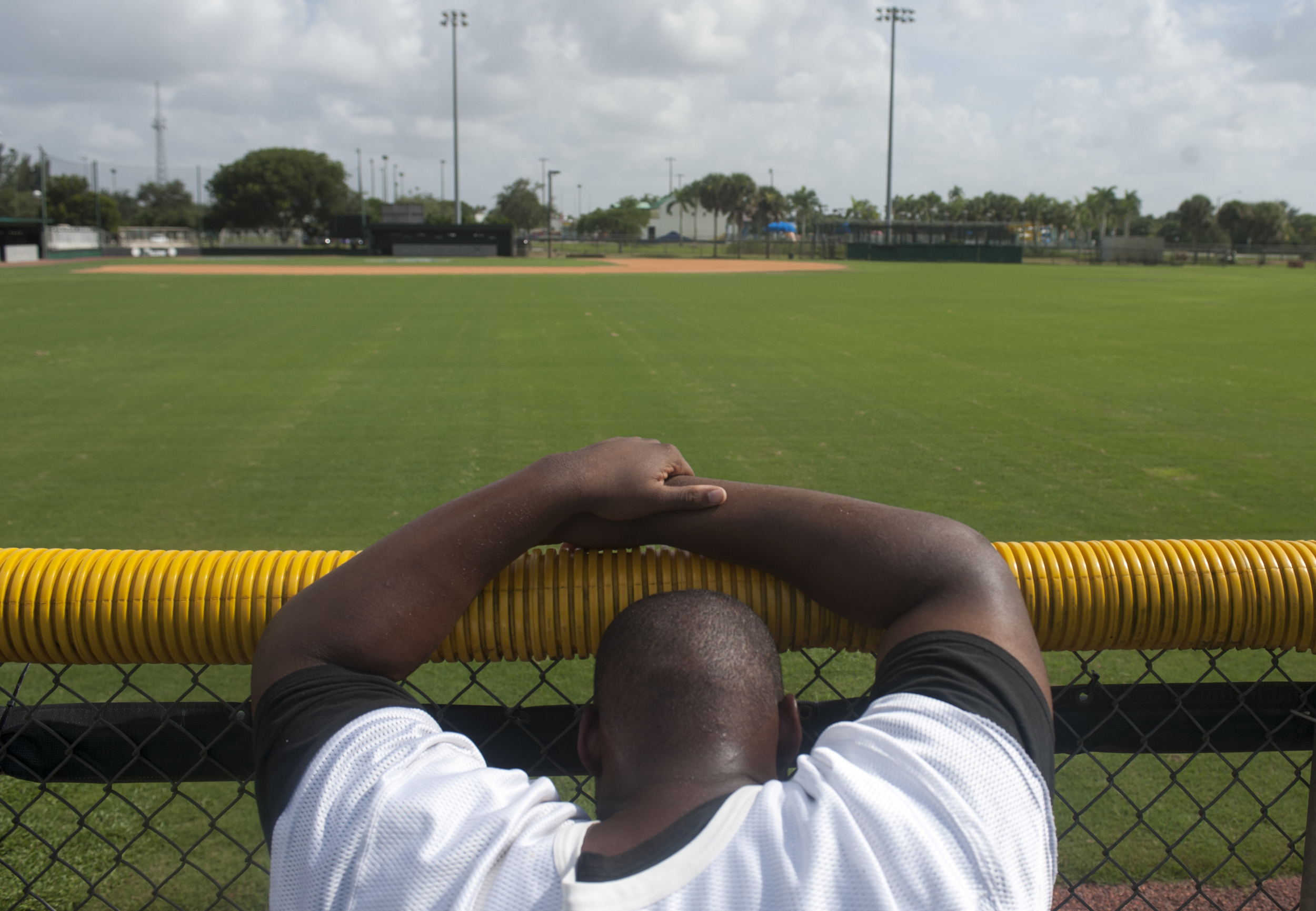  Flanagan high school senior offensive lineman Jamar Lambert leans on a fence after finishing wind sprints during the first practice of the high school football season at Flanagan High School on Monday, Aug. 1, 2016. The reigning state champions look