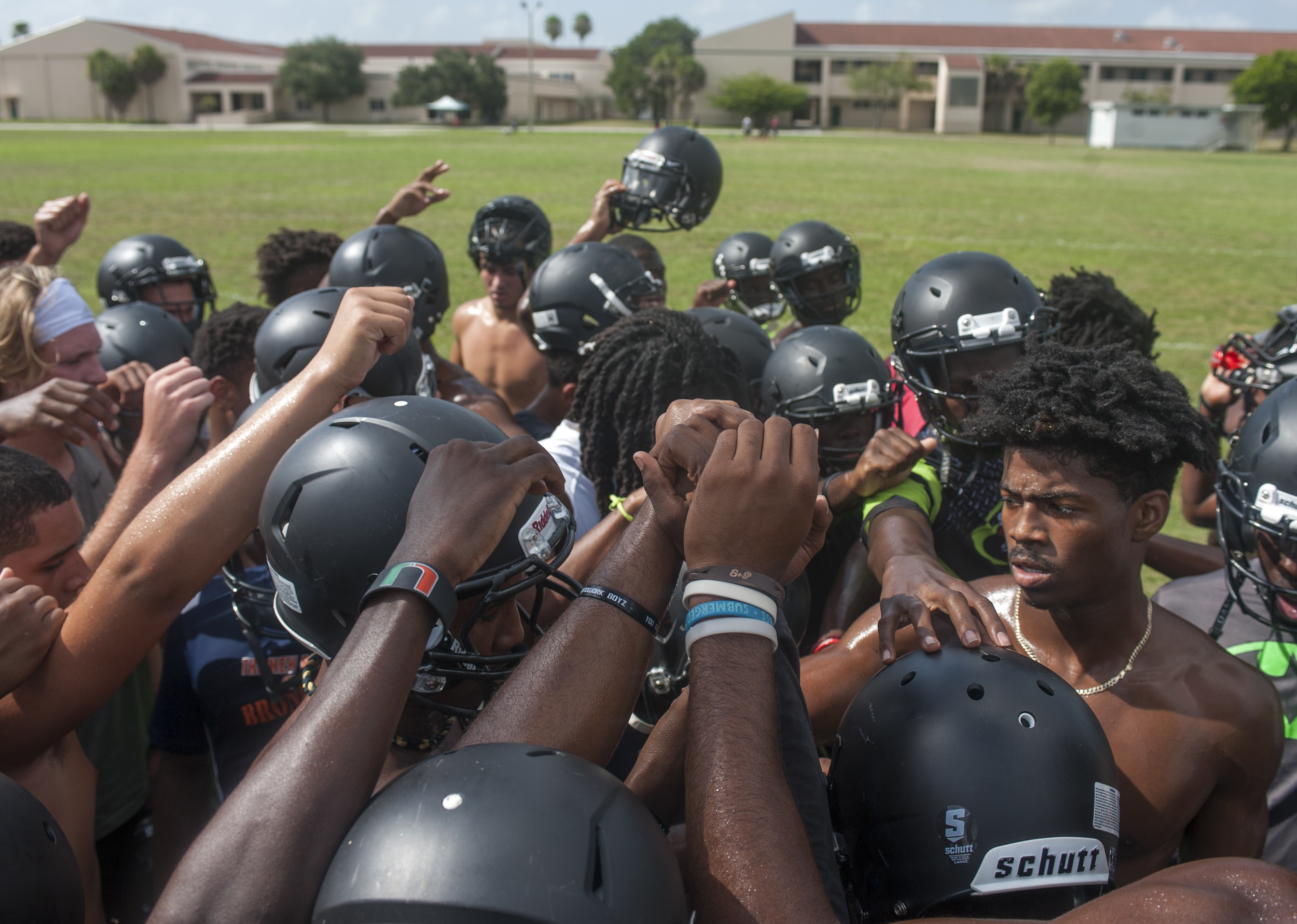  Flanagan high school senior Stanford Samuel III (right) leads in the breaking of practice after conditioning drills during the first practice of the high school football season at Flanagan High School on Monday, Aug. 1, 2016. The reigning state cham