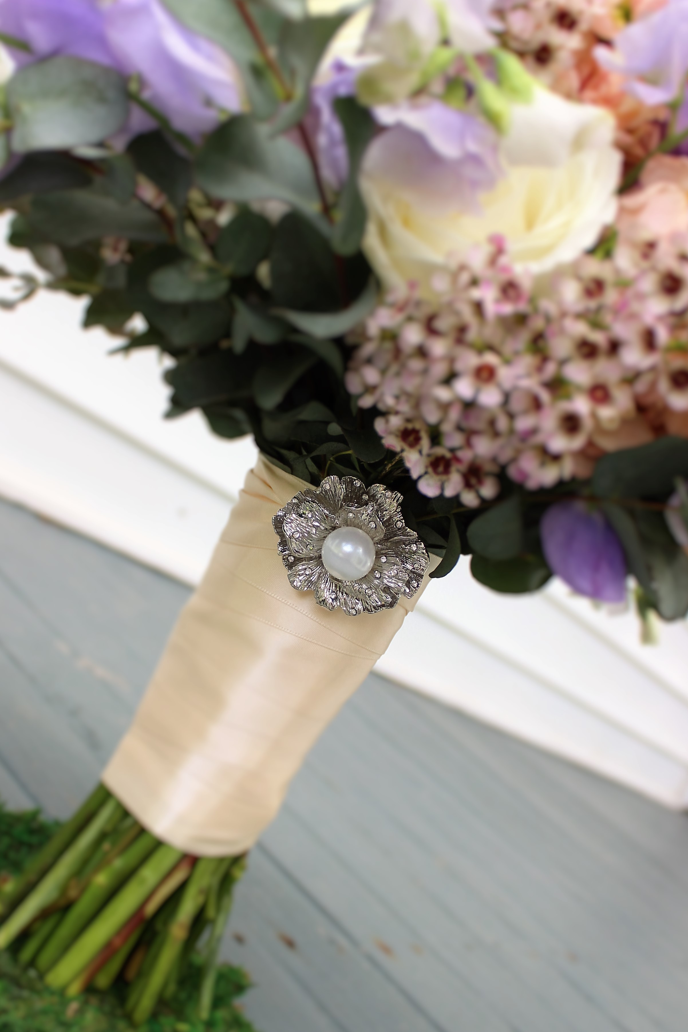 As a thank you, we add a sparkling keepsake brooch to all of our bride's bouquets! Each one is different and is chosen based on the bride's style. Photo by The Floral Cottage