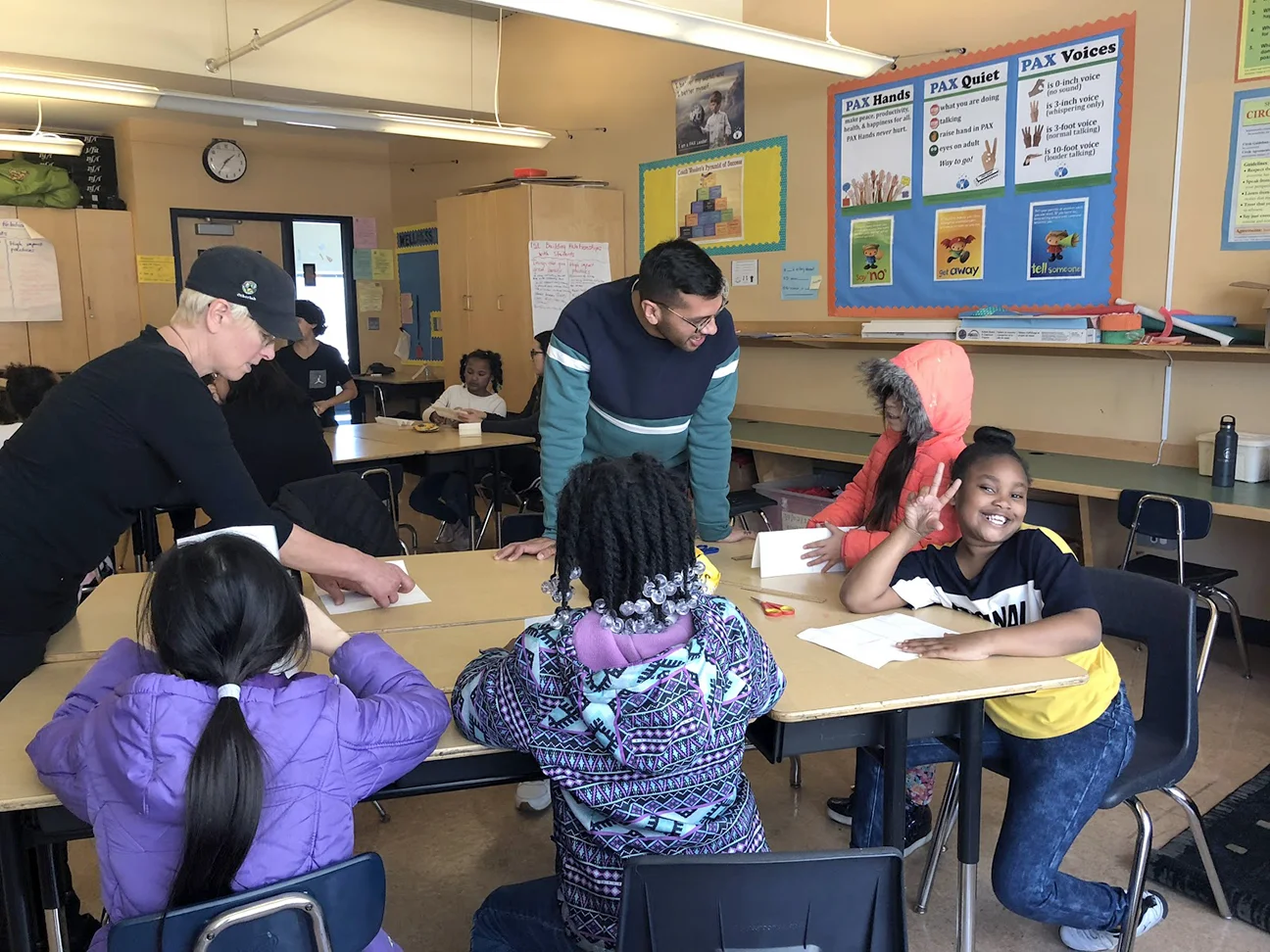 Mr. Eddie and Ms. Nan assisting students in the bookmaking process.