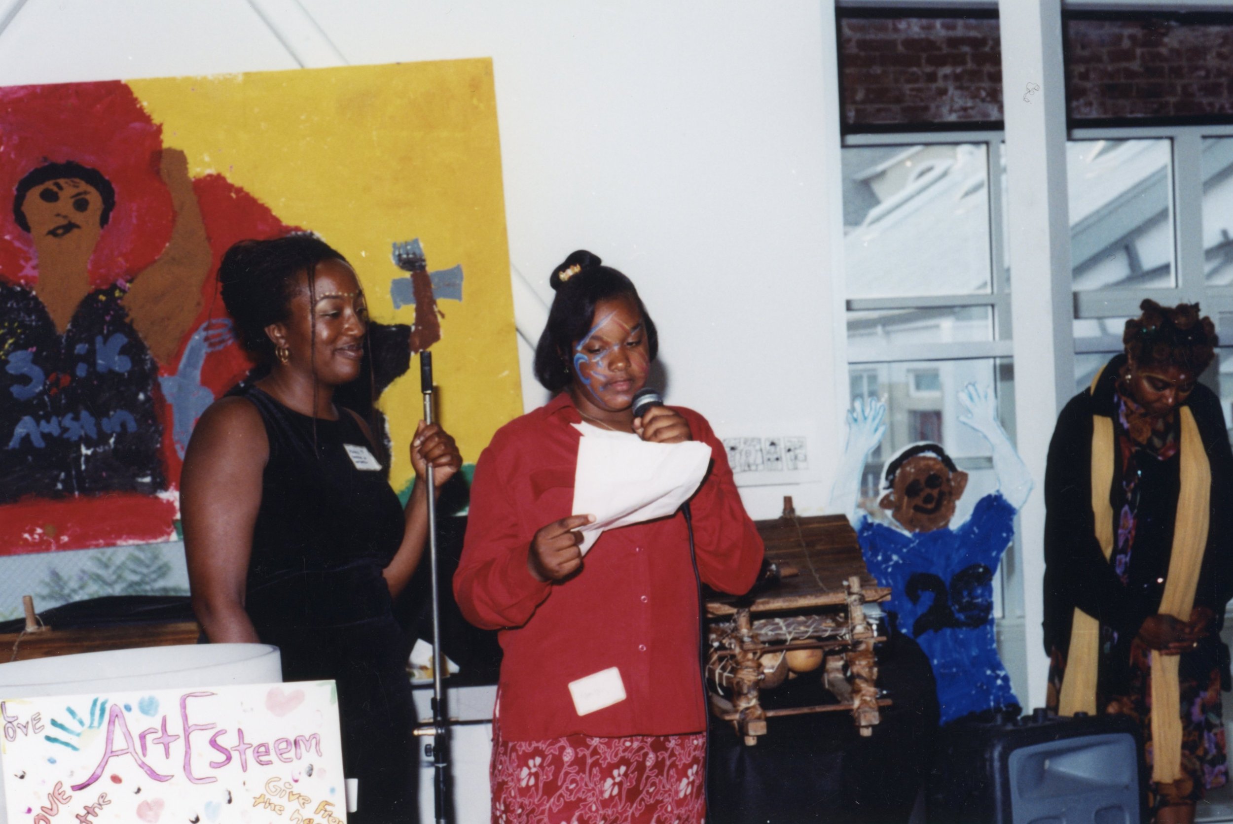   An ArtEsteem student, encouraged by Amana, speaking at an ArtEsteem annual exhibition.  