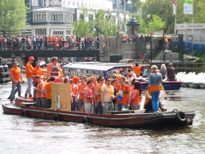 By land and by sea – revelers on King's Day in Amsterdam.