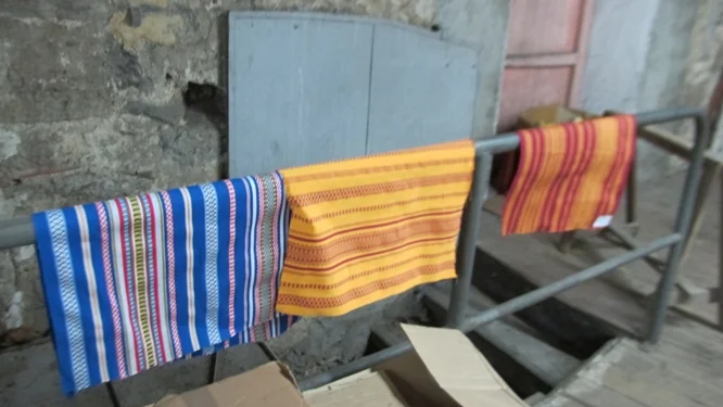 From top: The 38 colors of threads used to make all the colorways; a draft of a new pattern inspired by watermelons showing how additional shades are created by blending different colors of thread together; three of the original patterns from this factory. Photos Travellati Tours.