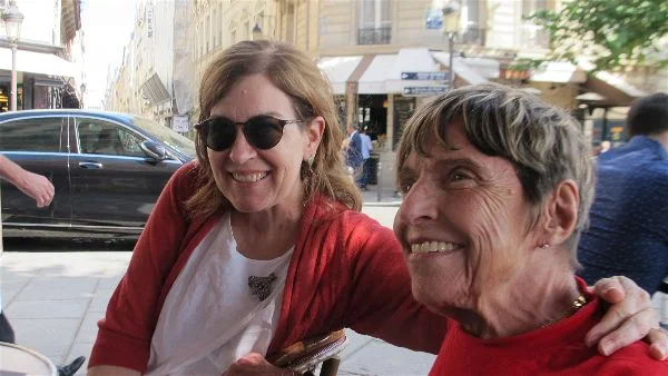 Travellati Tours guest Marietta (right) with a new friend at a café on the Ile Saint Louis, Paris, June 2017. Photo Travellati Tours.